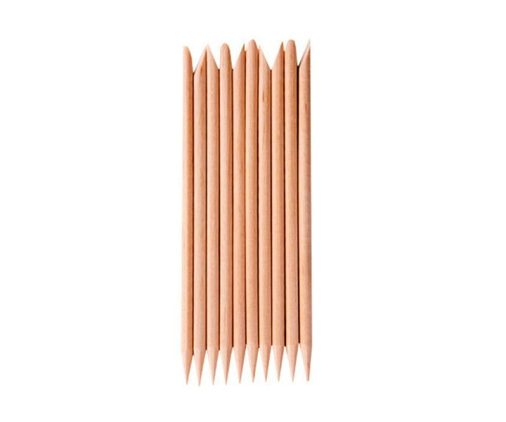 Ten wooden cuticle sticks arranged neatly, each pointed end up—an essential tool in the UNIQ Nail Starter Kit: Complete Gel Nail Set with 80W UV/LED Dryer by UNIQ, perfect for prepping nails before curing under your lamp.
