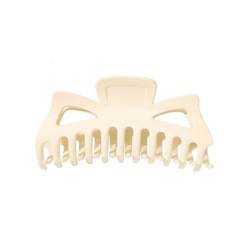 The SOHO Astrid Hair Claw - White by SOHO is a large plastic hair clip featuring wide, curved teeth and two triangular cutouts near the top—ideal for securing thick hair.