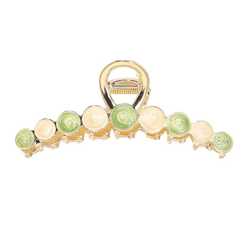 The SOHO Becca Hair Claw - Lime by SOHO features round, swirled cream and light green accents along the gold clip’s edge—ideal for adding secure, stylish flair to your hairstyle.