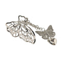 The SOHO Emy Metal Hair Claw - Butterfly features silver butterfly wings with chain-linked butterfly and heart charms. This detachable accessory by SOHO adds elegance and versatility to any hairstyle.