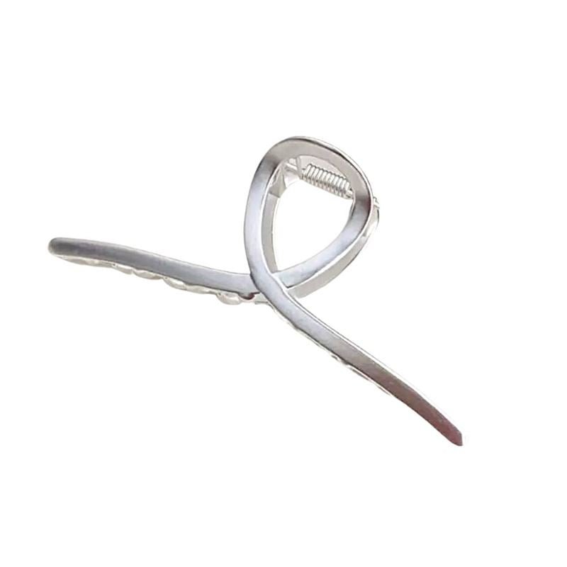 The SOHO Iva Metal Hair Claw - Silver by SOHO features a metallic open ribbon design, spring hinge, and serrated grip—ideal for fans of metal hair clips wanting a secure messy bun or an elegant hairstyle.