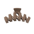 The SOHO Just Hair Claw - Brown by SOHO features five curved, interlocking prongs and a sleek plastic design—an essential accessory for effortless hair styling.