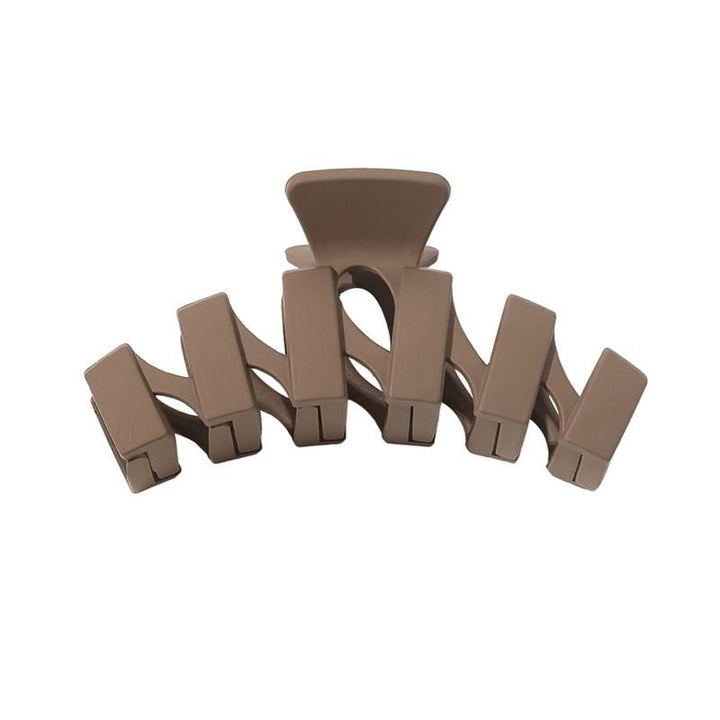 The SOHO Just Hair Claw - Brown by SOHO features five curved, interlocking prongs and a sleek plastic design—an essential accessory for effortless hair styling.