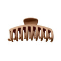 The SOHO Kana Hair Claw - Beige features wide, curved teeth for a strong grip on all hair types and is pictured against a white background.
