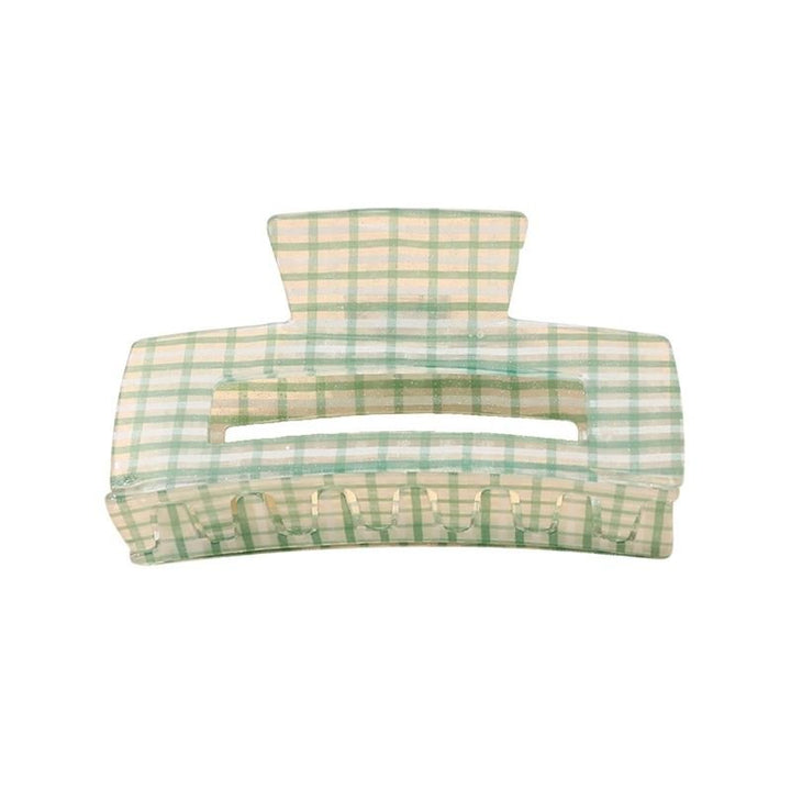 The SOHO Line Hair Claw - Green by SOHO is a large hair accessory in green and beige plaid, featuring interlocking teeth and a wide opening for a stylish, secure hold.