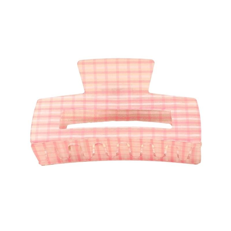 The SOHO Line Hair Claw - Pink by SOHO features a large, rectangular design with a pink chequered pattern and a central horizontal opening—perfect for securely holding your hair.