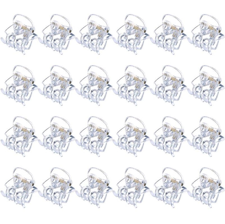 Twenty SOHO Lucca Mini Hair Claws - Transparent by SOHO, each featuring a silver metal spring and open to display their teeth, are arranged in a 4x6 grid on a white background.