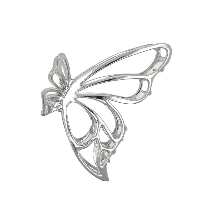 The SOHO Nabi Hair Claw in silver by SOHO features a delicate, openwork butterfly design with thin, curved lines forming the wings and body, beautifully displayed against a white background.
