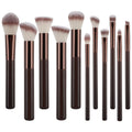 The Technique PRO Chocolate Bronze Makeup Brush Set includes 11 professional brushes with dark brown handles and rose gold ferrules, featuring various brush head shapes—such as a foundation brush—displayed upright against a white background.