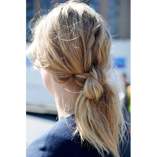 A person with light blonde hair in a loose topsy tail knot ponytail, styled using the Fashiongirl Topsy Tail Hair Styling Tool 2 Piece Set—perfect for easy ponytails, buns, and braids.