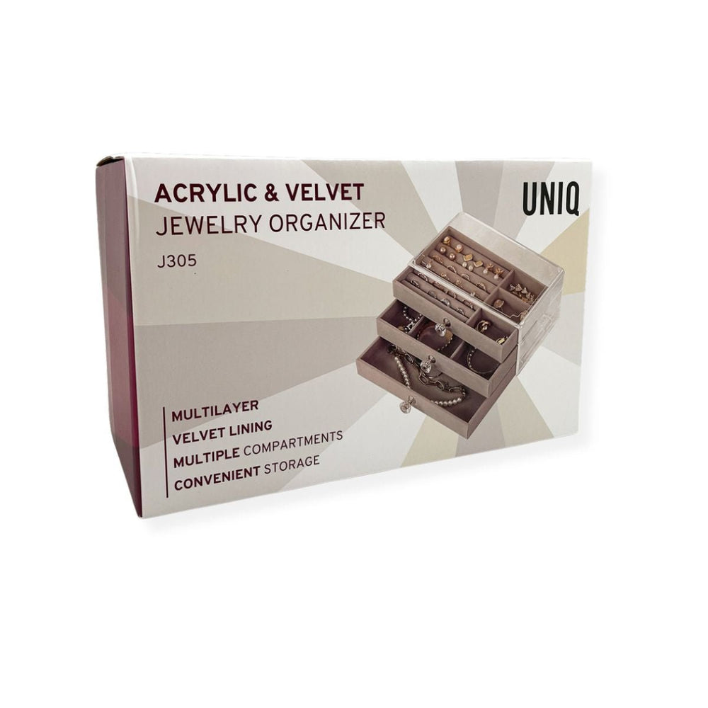 A box for the UNIQ Acrylic Jewellery Organiser with 3 drawers (J305) shows the organiser filled with jewellery. Key features: multilayer design, velvet lining, multiple compartments, and convenient storage. Brand: UNIQ.