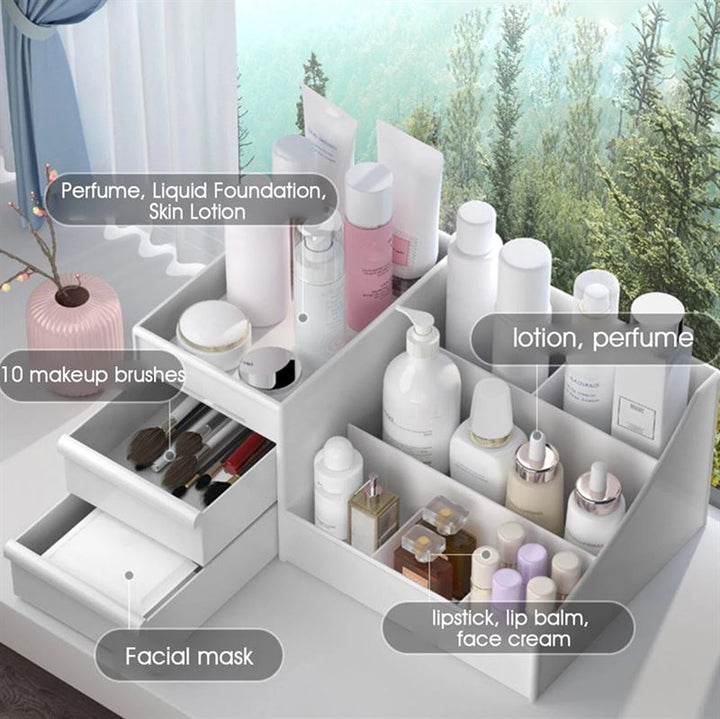 The UNIQ Cosmetic Organiser with Two Drawers, White - P110 by UNIQ neatly stores skincare and makeup like labeled bottles, perfume, brushes, masks in drawers, and lipsticks—all arranged by a window with a view of greenery.