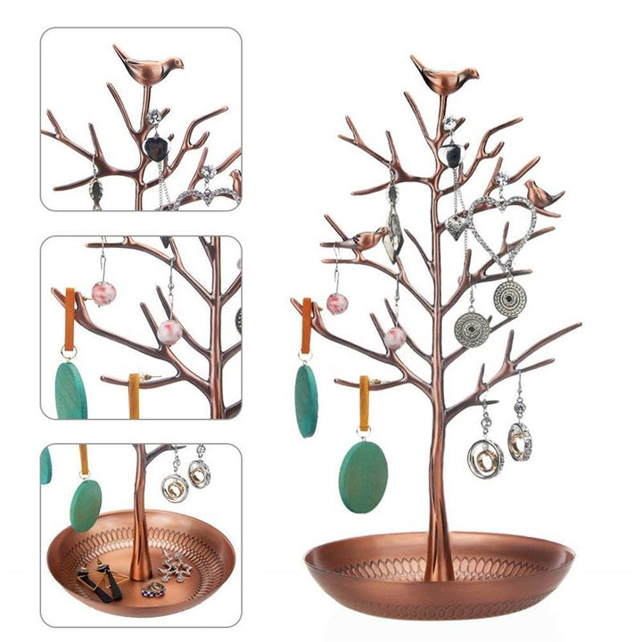 The UNIQ Bronze Vintage Jewelry Tree with 3 Birds is a stylish organizer display stand, perfect for showcasing necklaces, earrings, and rings. Three insets show vintage jewelry hanging from the branches and resting in the base dish.